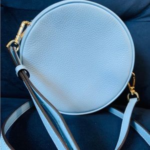 like new. A pretty bag in pale blue color, not my style anymore.